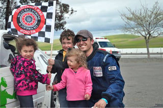 Josh at the racetrack with his kids.