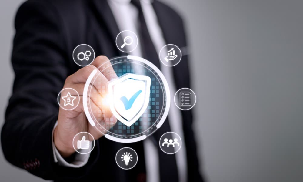 A businessman clicks on a screen with a shield and checkmark in the center of a circle. 