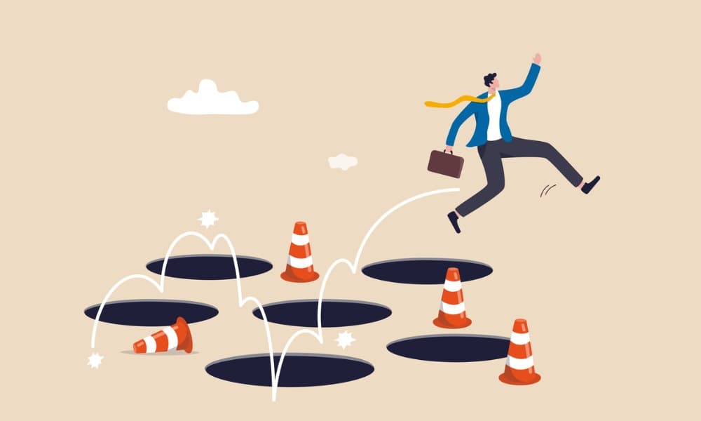 The image displays a cartoon image of a man jumping over holes and orange cones.