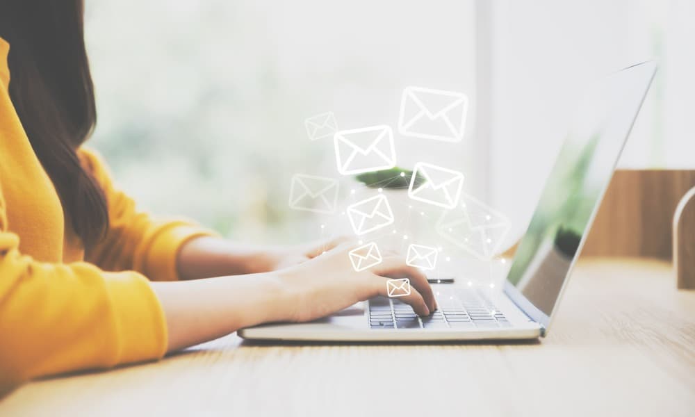 business person typing an email on a computer